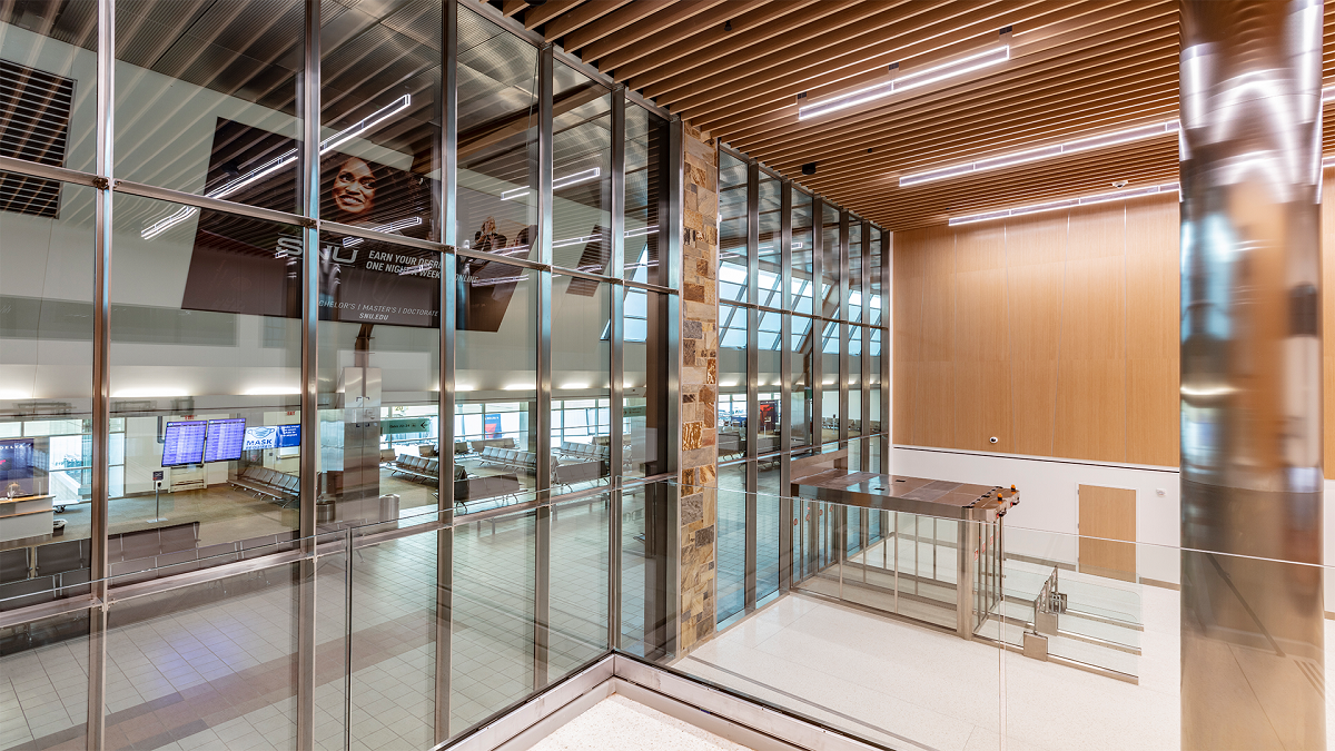 Interior view of a modern building lobby with tall glass curtain walls.